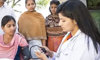 Lady doctor taking blood pressure