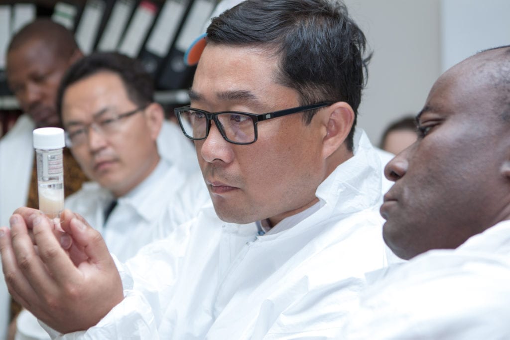 Scientist looking at a test tube